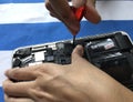 User of Apple Mac book laptop is changing battery by herself